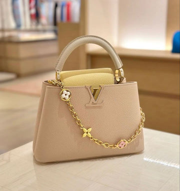 Louis Vuitton Taurillon Enamel Flower Chain Capucines BB in a beige, yellow, and creme colorway