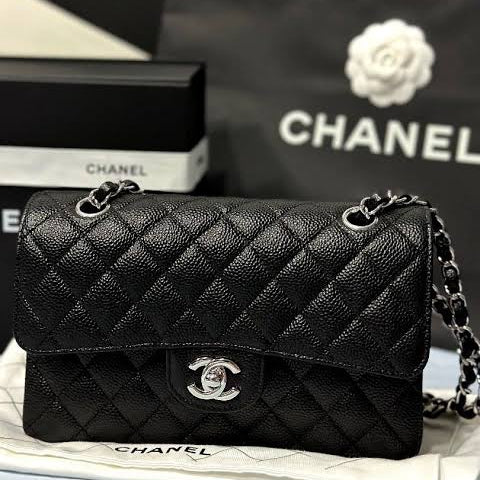 Chanel Classic Double Flap Bag in black caviar leather with silver-tone hardware.