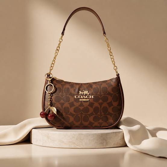 Coach Teri Shoulder Bag in Signature Canvas (brown and tan), decorated with a gold-tone cherry keychain