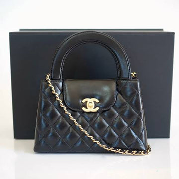 Chanel Kelly Shopping Bag (often called the Chanel Nano or Mini Kelly Shopper) in black quilted leather with a silver-tone CC turn-lock closure.